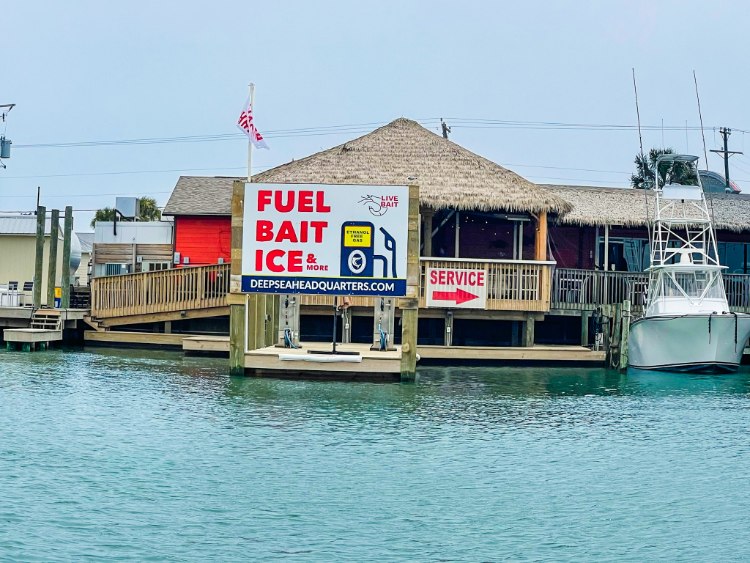 Fuel, Bait, and Ice Sign at Deep Sea Headquarters to show job responsibilities for positions in port aransas